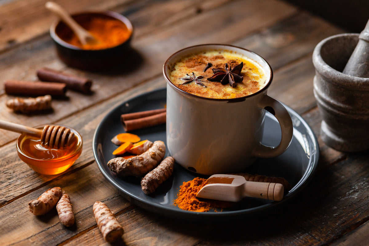 Turmeric golden milk latte with cinnamon sticks, star anise and honey