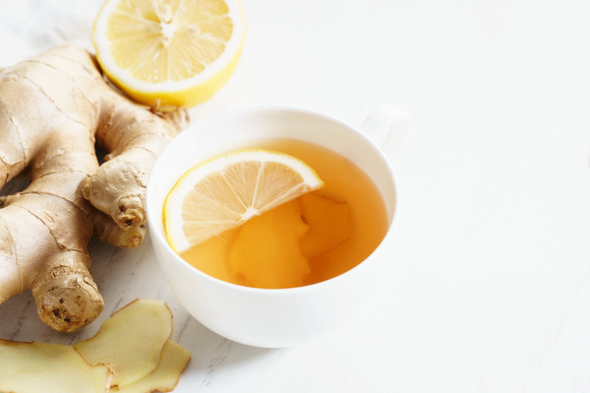 Fresh ginger tea with lemon slice in a cup